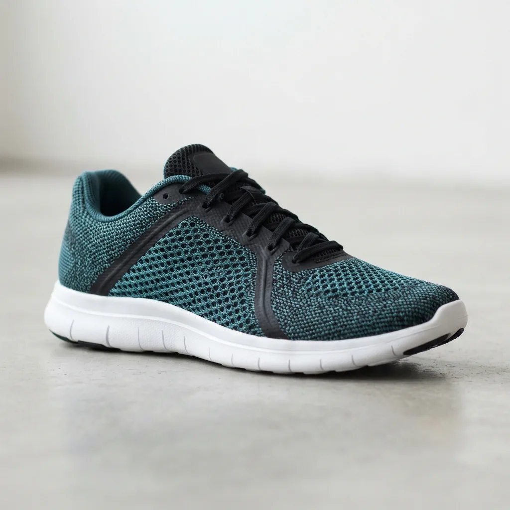 One unbranded lightweight running shoe with a slim mesh upper photographed in three-quarter view on a light studio surface