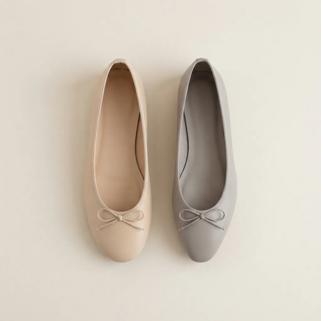 Two unbranded ballet flats with different toe shapes lined up on a pale backdrop