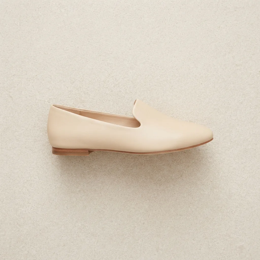 A single minimal modern flat with a clean line photographed from above on a pale stone surface