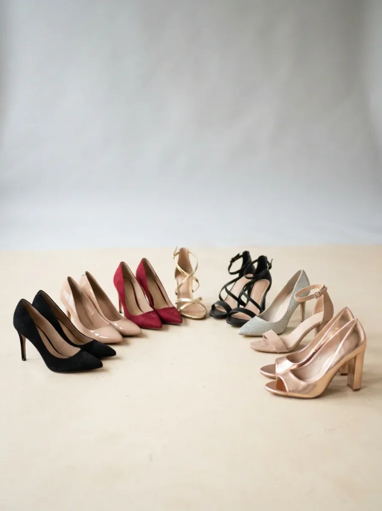 Assortment of women's high heels arranged on a bright cream studio floor